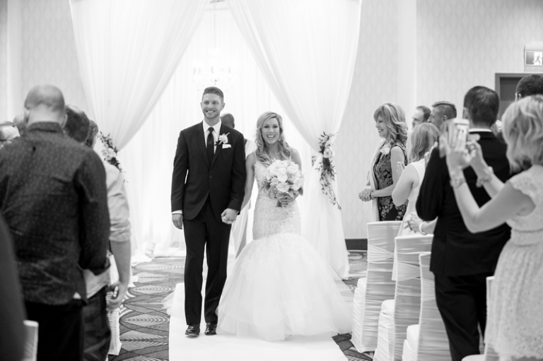 The newlyweds walk down the ceremony aisle in Regina, SK