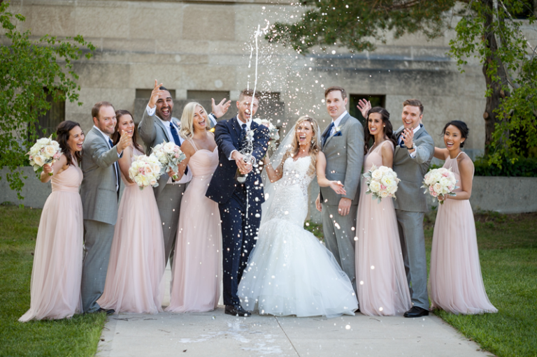 Bridal party champagne pop by Collin Stumpf Photography