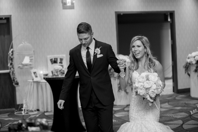 Bride & groom entering their reception at the DoubleTree Hilton Regina