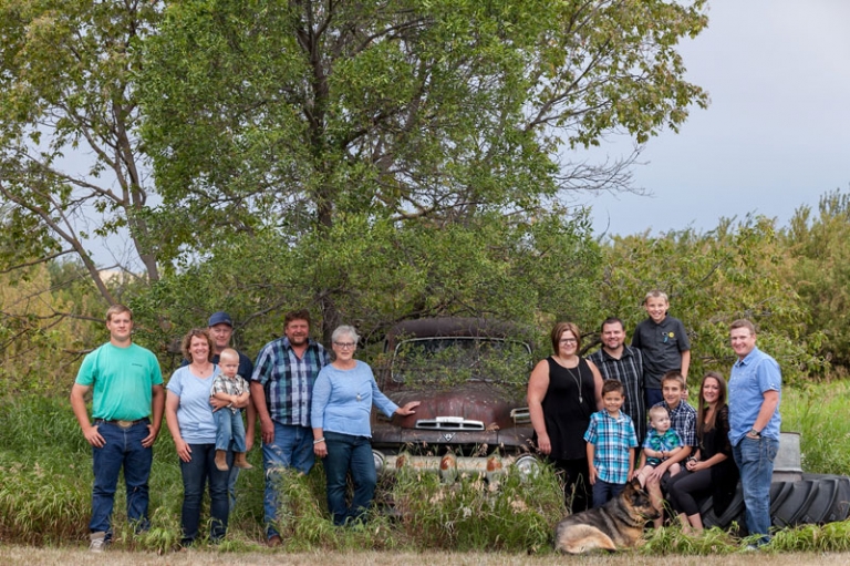 Family photograph on the farm with old rusty truck and tree by Collin Stumpf Photography