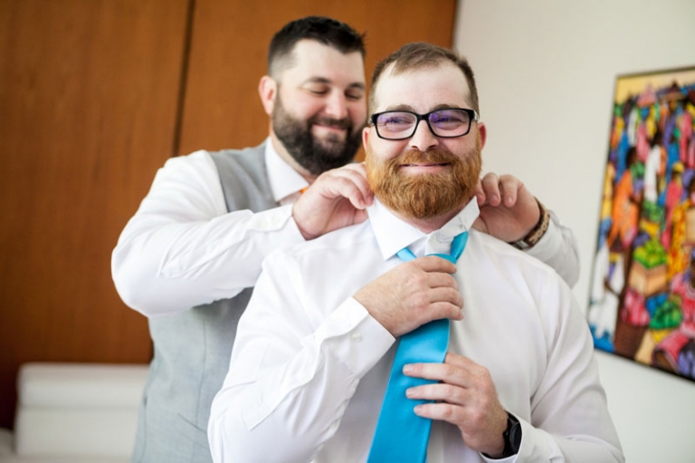 Groom doing up tie