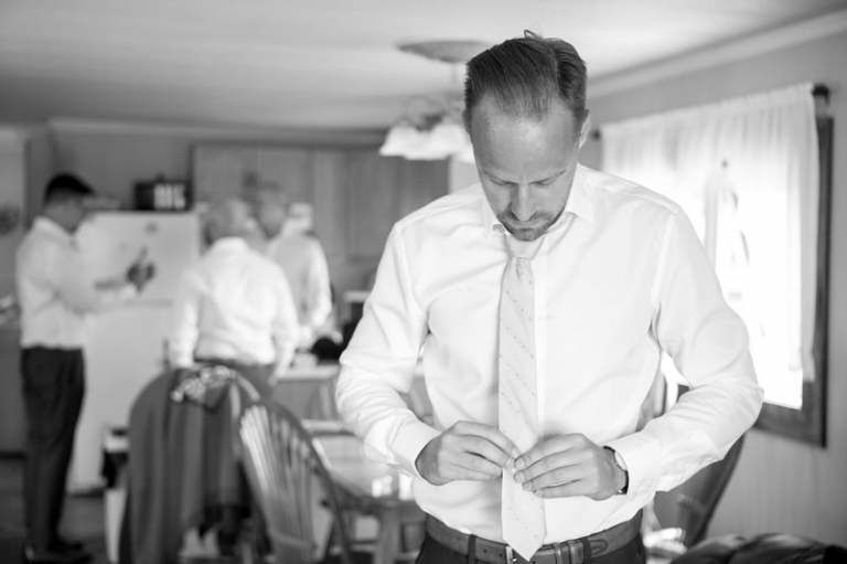 groom fixing tie