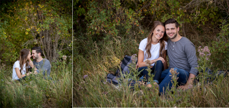 Couple sitting on blanket with trees and tall grass