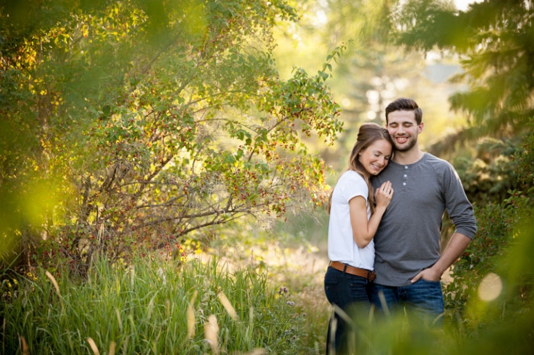 couple cuddled together in trees and golden evening light