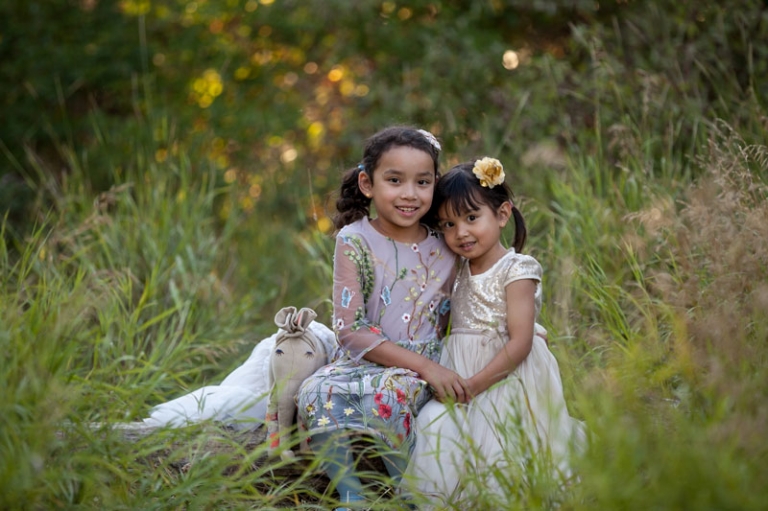Sisters hugging during family photo session by Collin Stumpf