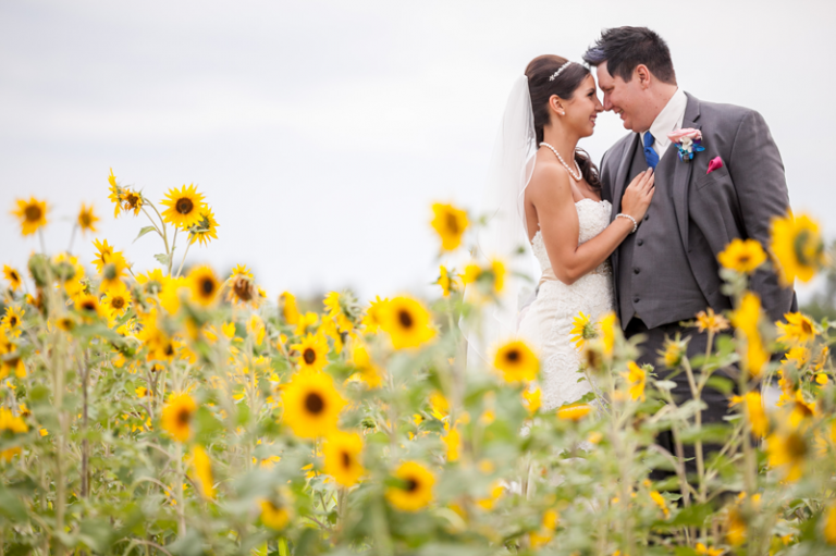 Bride and Groom with sunflowers by Collin Stumpf