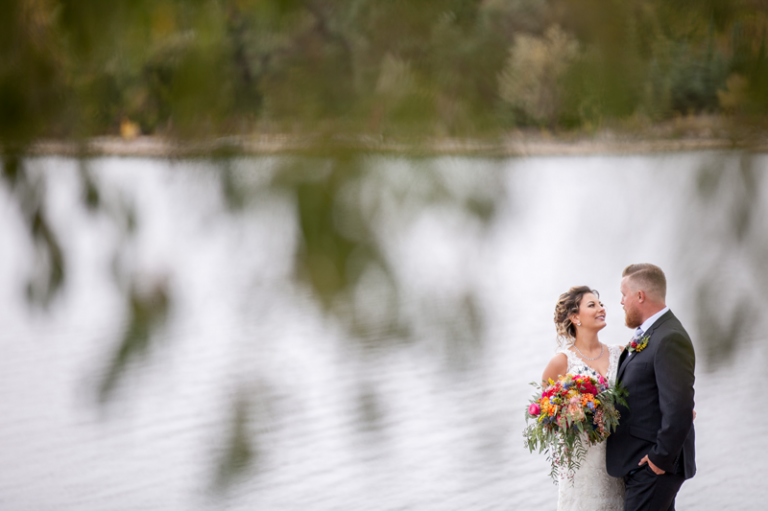 Bride and Groom beside the lake by Collin Stumpf Photograph
