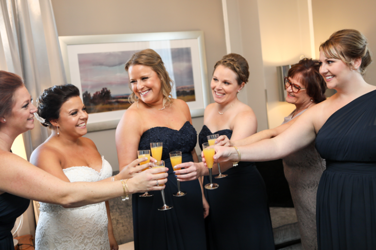 Bride and her Bridesmaids drinking mimosas Collin Stumpf Photography