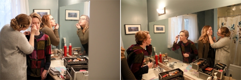 Bride and bridesmaids doing makeup on wedding morning