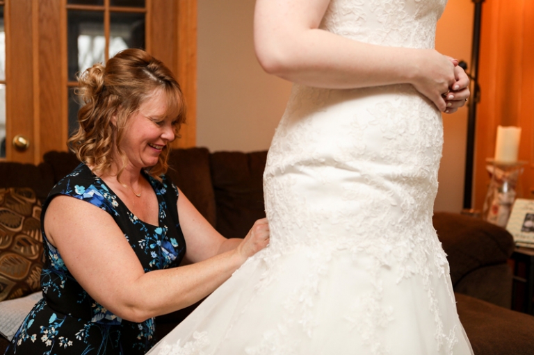 mother doing bride's dress up