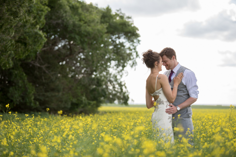 Collin sStumpf Photography bride and groom in canola field