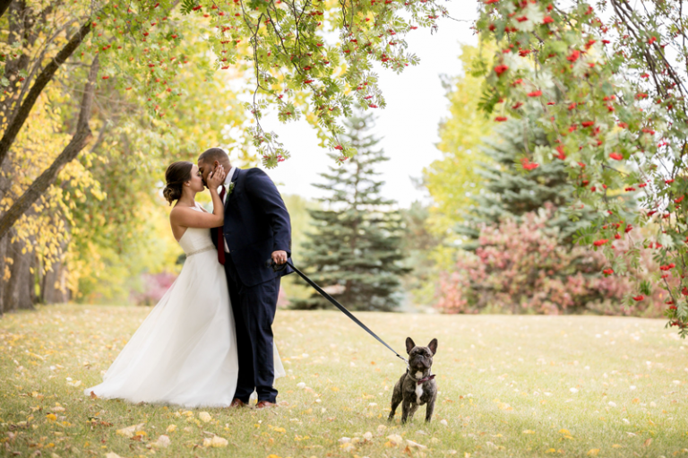 bride and groom with puppy